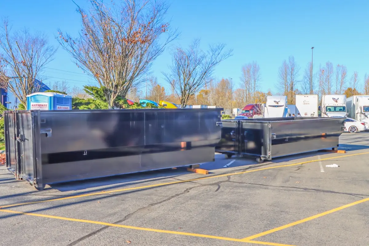 Professional dumpster rental service with roll-off container on residential driveway in Richfield